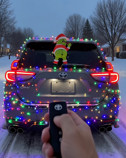 GrinchMist on a Christmas-lights car, remote in hand