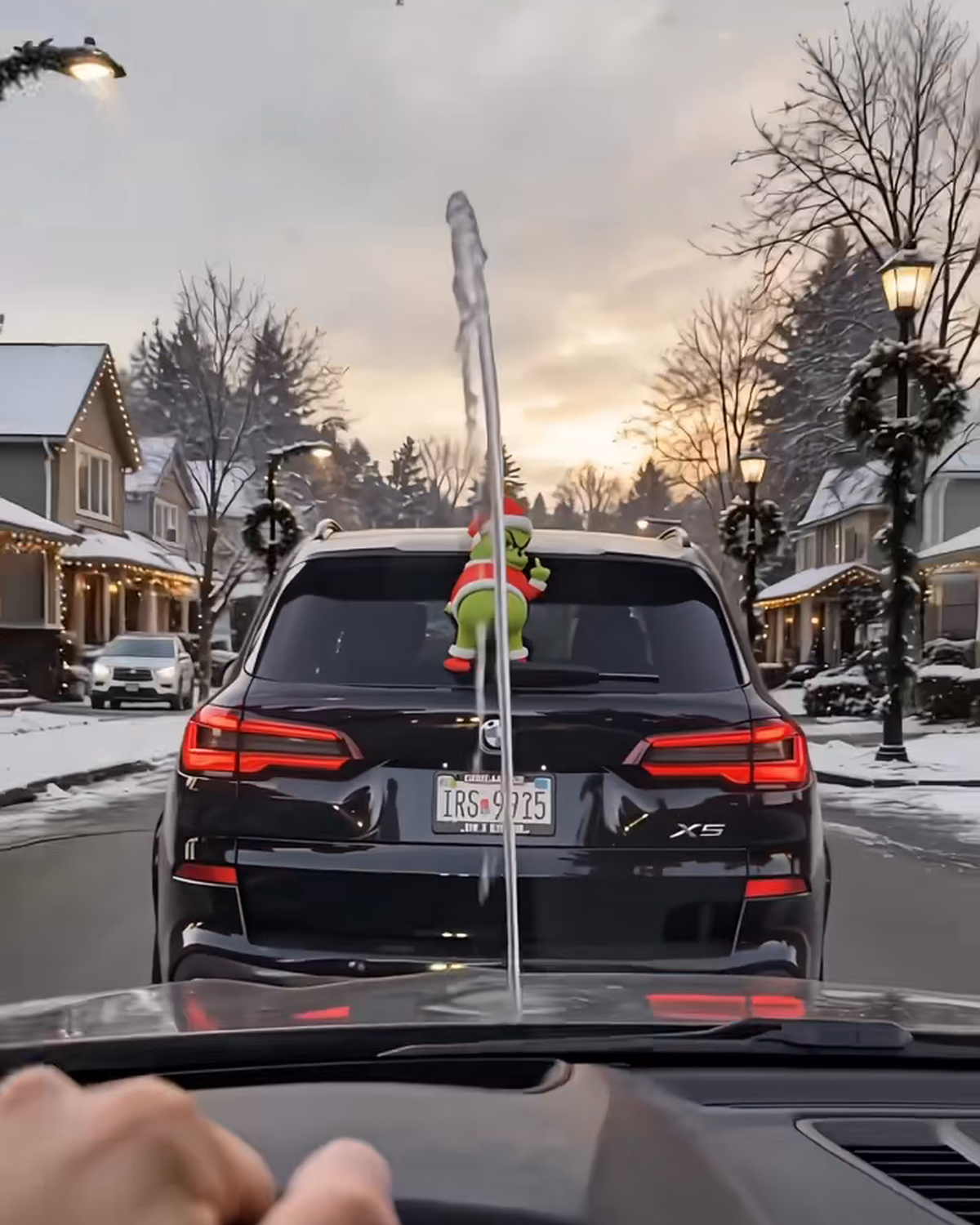 GrinchMist spraying a water arc at the car behind